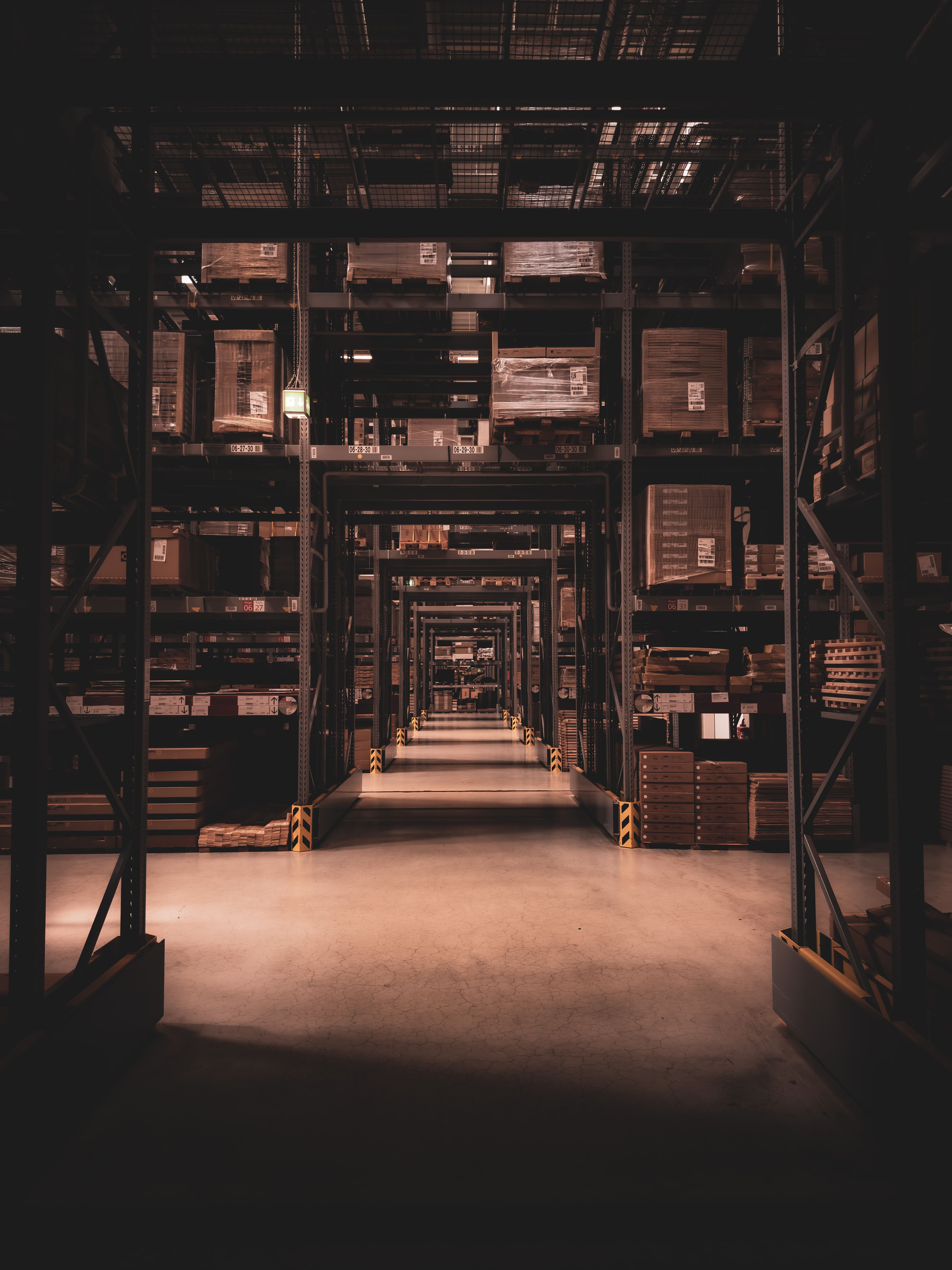 Rows of identical stored goods receding into darkness